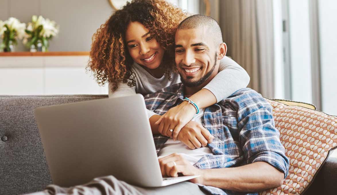 couple researching home equity on their laptop